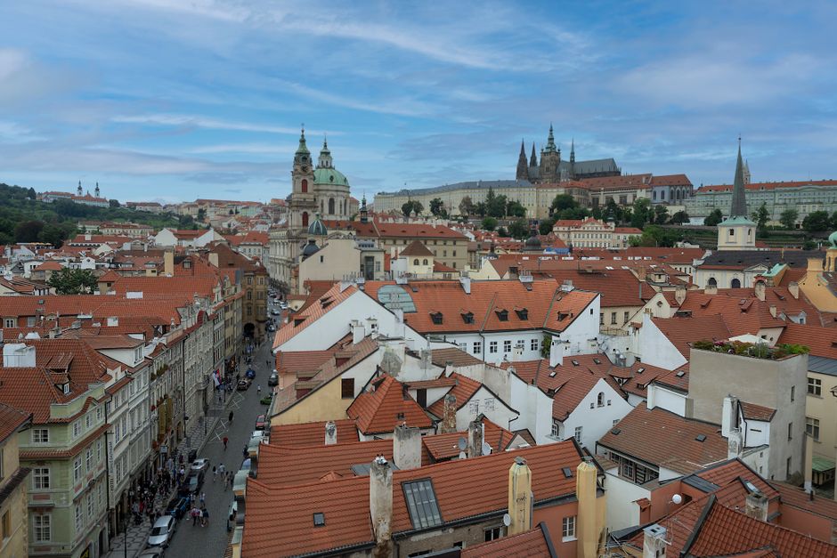 Explore the stunning aerial view of Prague's iconic red rooftops and historic architecture.