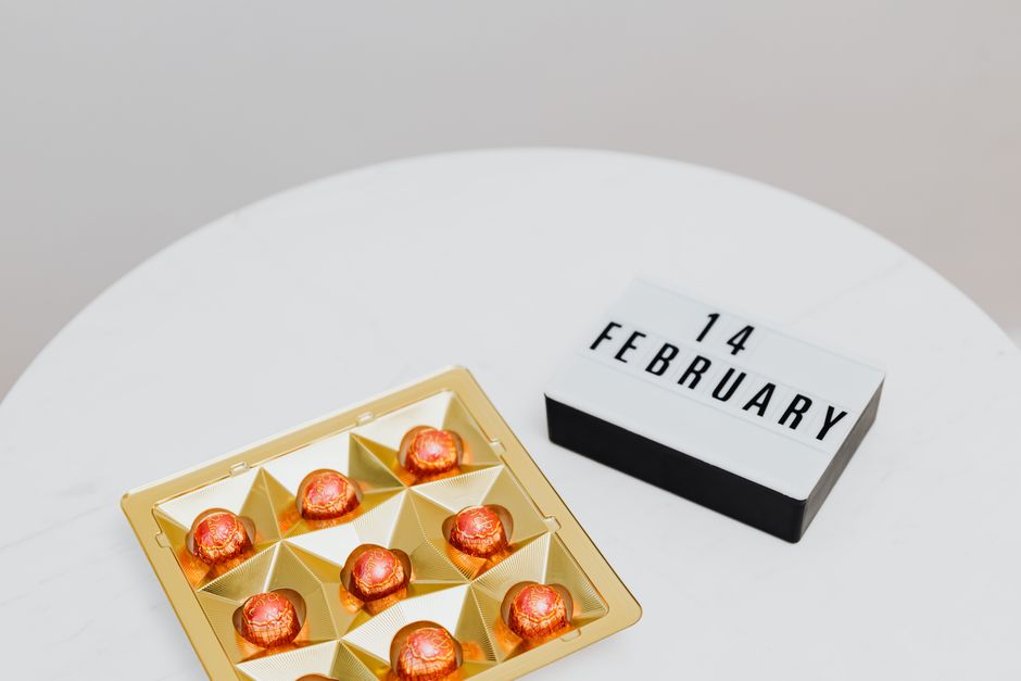 A gold box of chocolate pralines with 14 February sign, highlighting Valentine's Day.
