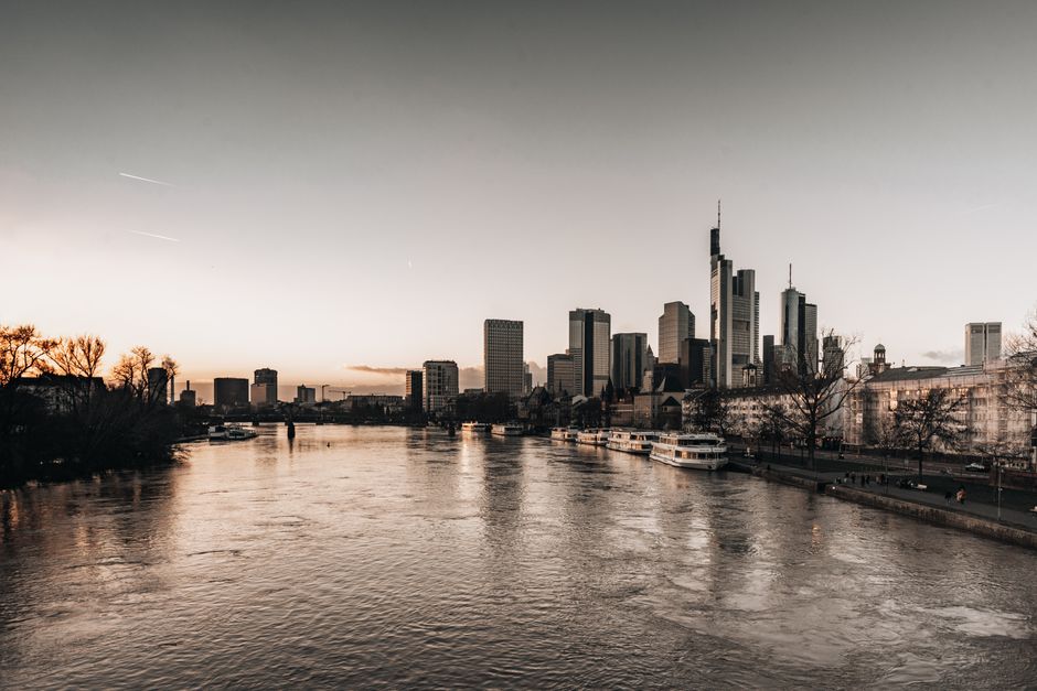 Captivating view of Frankfurt's skyline along the river at twilight, showcasing modern architecture.