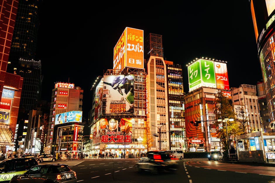 Bright cityscape of Shinjuku, Tokyo, showcasing vibrant neon lights and bustling streets.