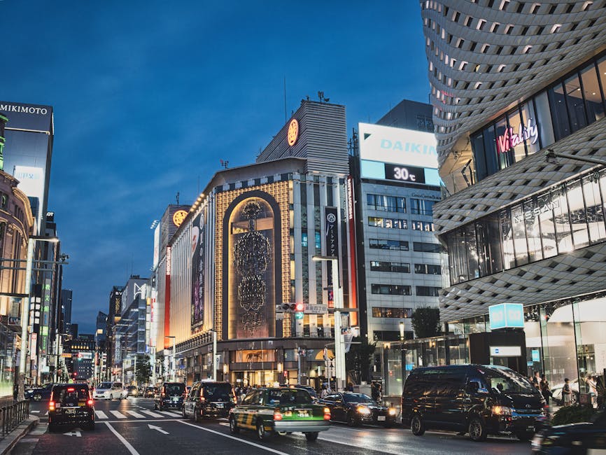 A bustling evening view of the famous Ginza district in Tokyo, showcasing vibrant city life and architecture.