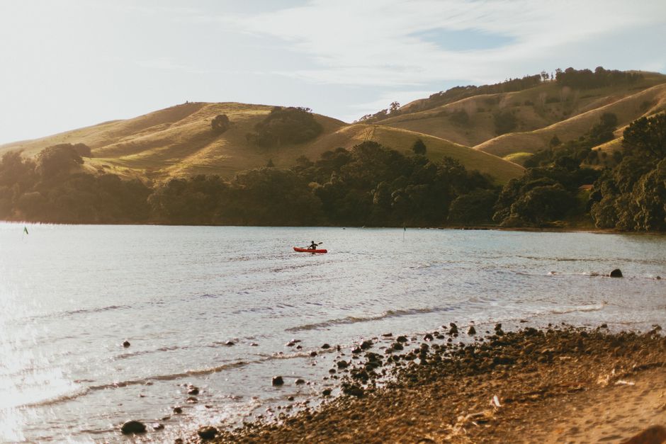A serene scene of kayaking at Coromandel, showcasing New Zealand's natural beauty.