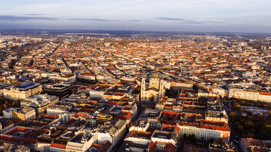 Stunning aerial view of Budapest featuring St. Stephen's Basilica under a bright sky.