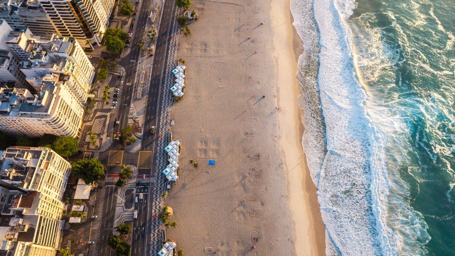 Stunning aerial view of Copacabana Beach with golden sunlight illuminating the coastline i