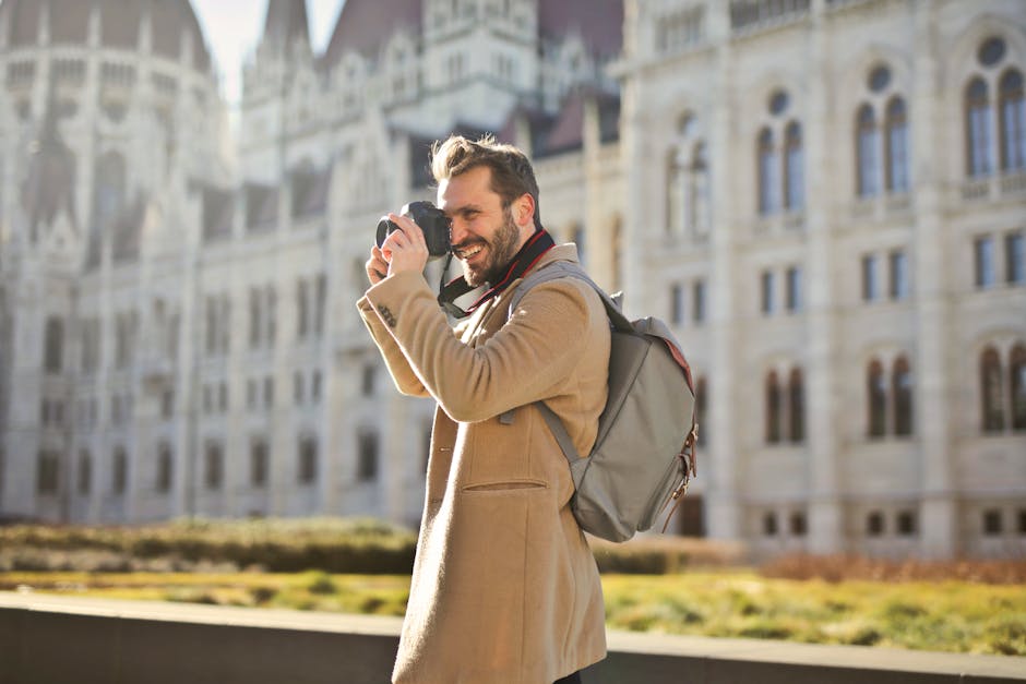 Tourist capturing photos outside the Parliament Building in Budapest, Hungary.