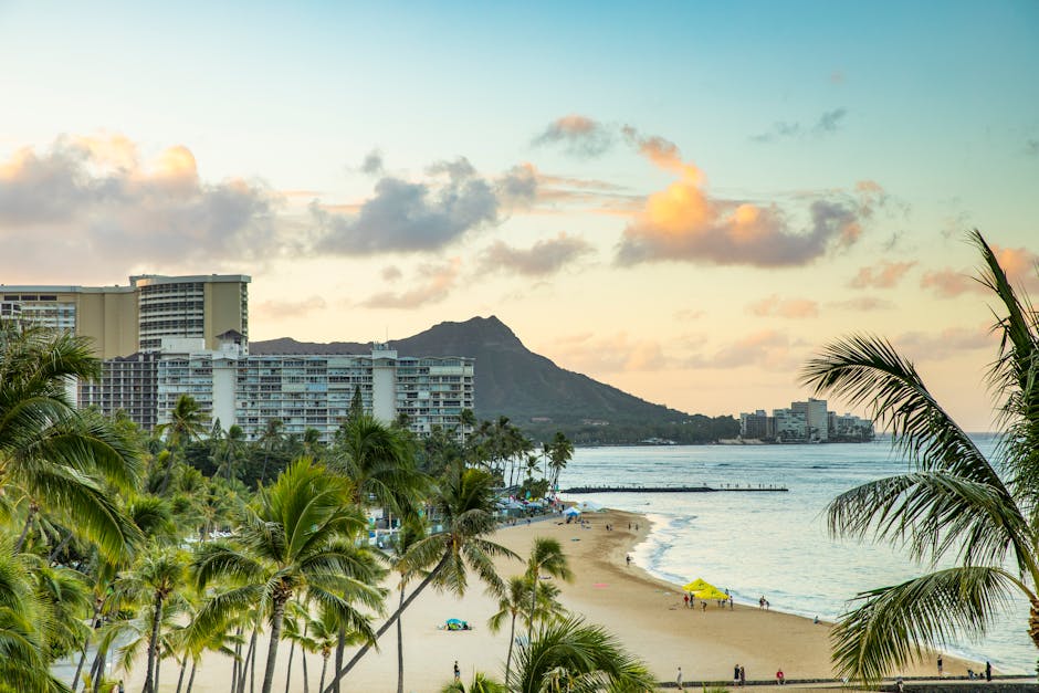 A serene view of Waikiki Beach and iconic Diamond Head at sunset, perfect for travel inspiration.